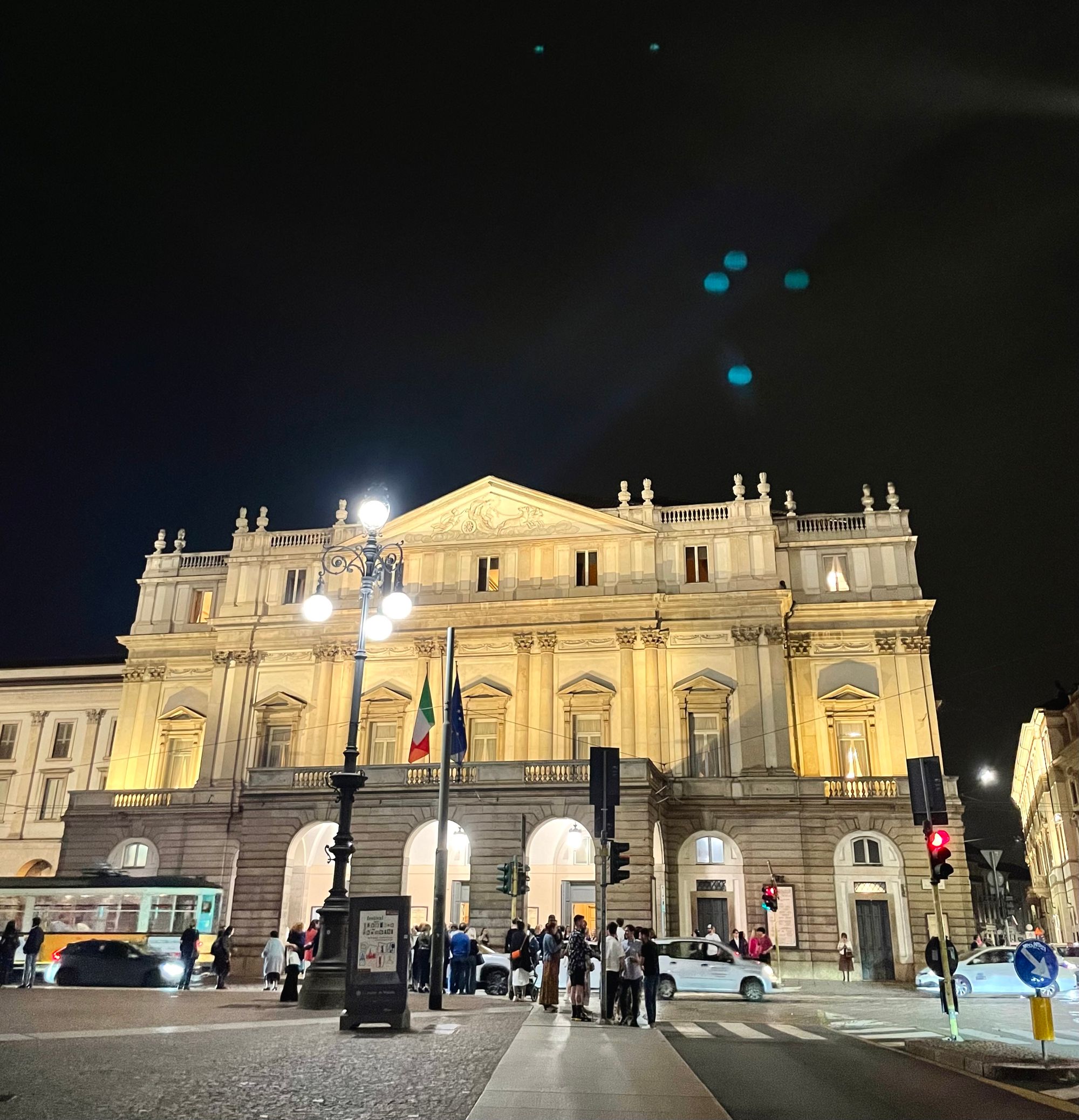 The well-lit façade of la Scala opera house after the opera at night